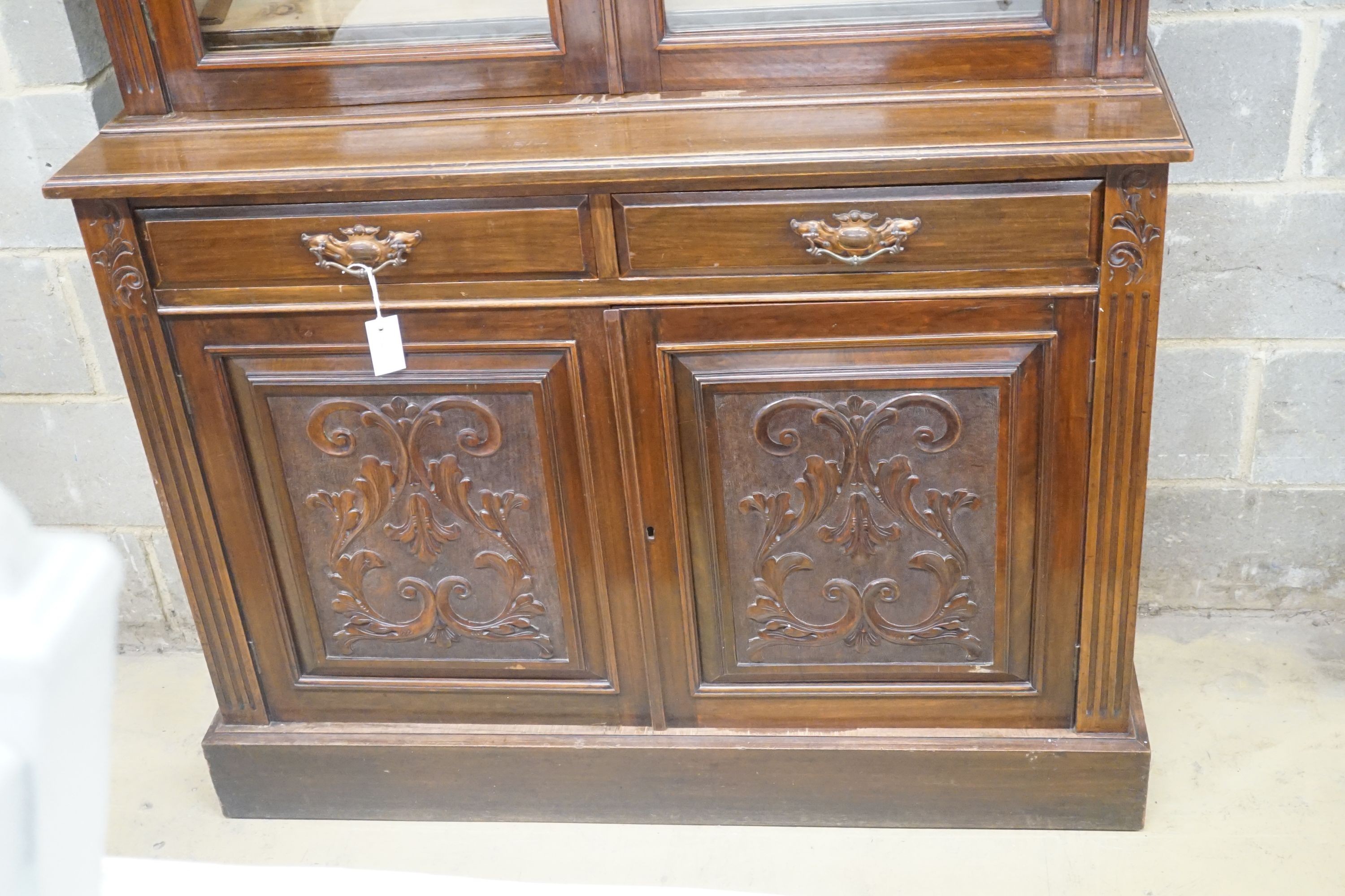 A late Victorian carved walnut bookcase, width 120cm depth 43cm height 220cm